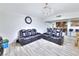 Open concept living room with wood look flooring, and a kitchen in the background at 4735 Monterrey Ave, Las Vegas, NV 89121