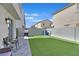 The backyard offers artificial grass, a gray cinderblock fence and plenty of room to entertain at 4932 Chidlaw Ave # 2, Las Vegas, NV 89115