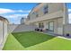 Backyard area features well-kept artificial grass, a privacy fence, and patio space at 4932 Chidlaw Ave # 2, Las Vegas, NV 89115
