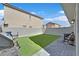 The backyard shows a barbecue and table on an artificial lawn with the house in the background at 4932 Chidlaw Ave # 2, Las Vegas, NV 89115