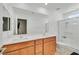 Bathroom with a large mirror, double sinks, and a glass-enclosed shower area at 4932 Chidlaw Ave # 2, Las Vegas, NV 89115