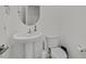 Clean half-bathroom featuring a pedestal sink, toilet, and classic fixtures, ideal for guests at 4932 Chidlaw Ave # 2, Las Vegas, NV 89115