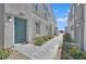 Charming gray home with a light blue front door, complemented by a stone pathway and manicured landscaping at 4932 Chidlaw Ave # 2, Las Vegas, NV 89115