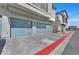 This is a three car garage with light blue doors and brick driveway at 4932 Chidlaw Ave # 2, Las Vegas, NV 89115