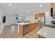 Open-concept kitchen and living room with stainless steel appliances, a breakfast bar, and a comfortable sectional at 4932 Chidlaw Ave # 2, Las Vegas, NV 89115