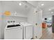 Convenient laundry area with modern washer and dryer, plus view into open floor plan at 4932 Chidlaw Ave # 2, Las Vegas, NV 89115