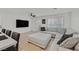Bright living room with a large sectional sofa, modern ceiling fan, and a mounted flat screen TV at 4932 Chidlaw Ave # 2, Las Vegas, NV 89115