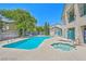 Community pool area includes a pool, jacuzzi, lounge chairs, and shaded areas perfect for relaxation and socializing at 5151 Lindell Rd # 103, Las Vegas, NV 89118