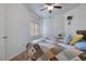 The bedroom features comfortable bedding and modern ceiling fan with natural light from the window at 5224 Jose Ernesto St, North Las Vegas, NV 89031
