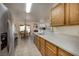 Bright kitchen features stainless steel appliances, wood cabinets, and eat-in dining area at 5224 Jose Ernesto St, North Las Vegas, NV 89031