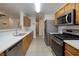 Functional kitchen layout features stainless steel appliances, ample counter space, and tile flooring throughout at 5224 Jose Ernesto St, North Las Vegas, NV 89031