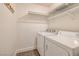 The laundry room has a modern washer and dryer with extra shelving at 5224 Jose Ernesto St, North Las Vegas, NV 89031