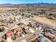 Aerial view of a quiet neighborhood surrounded by mountains and open land at 5450 Barnwood Ct, Pahrump, NV 89061
