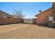 This backyard features low-maintenance gravel landscaping and secure privacy wall at 5450 Barnwood Ct, Pahrump, NV 89061