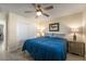 Comfortable bedroom with a large window, ceiling fan, closet, and stylish furniture for a cozy retreat at 5450 Barnwood Ct, Pahrump, NV 89061