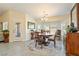 Open dining room with round table, decorative furnishings, and backyard access at 5450 Barnwood Ct, Pahrump, NV 89061