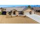 Charming single-story home featuring a three-car garage and desert landscaping at 5450 Barnwood Ct, Pahrump, NV 89061