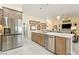 Kitchen showcasing stainless steel appliances, wood cabinets, and an island with sink at 5450 Barnwood Ct, Pahrump, NV 89061