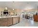 Open kitchen and dining area featuring a kitchen island with stainless steel appliances at 5450 Barnwood Ct, Pahrump, NV 89061