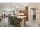 Kitchen island with seating, pendant lighting, and stainless steel appliances, perfect for casual dining and meal preparation at 5450 Barnwood Ct, Pahrump, NV 89061