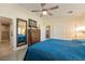Bedroom featuring blue bedding, a dresser, and an ensuite bathroom and closet at 5450 Barnwood Ct, Pahrump, NV 89061