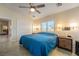 Bedroom featuring blue bedding, neutral walls, and double door closet at 5450 Barnwood Ct, Pahrump, NV 89061