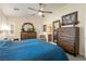 Spacious main bedroom featuring stylish rustic wood furnishings, ceiling fan, and lots of light at 5450 Barnwood Ct, Pahrump, NV 89061