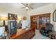 Home office with a desk, computer, large windows, bookshelves, and comfortable seating at 5450 Barnwood Ct, Pahrump, NV 89061