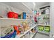 Walk-in pantry featuring organized shelving with various food and household items at 5450 Barnwood Ct, Pahrump, NV 89061