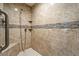 Walk-in shower featuring beautiful tile surround, built-in shelves, and shower head at 5450 Barnwood Ct, Pahrump, NV 89061