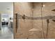Elegant walk-in shower with glass door, seat, grab bar and handheld shower head at 5450 Barnwood Ct, Pahrump, NV 89061