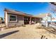 Home's backyard features desert landscaping, grill area, and a covered patio at 5552 Singing Hills Dr, Las Vegas, NV 89130