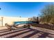 Beautiful backyard with tiled bench seating, brick fire pit, and desert landscaping at 5552 Singing Hills Dr, Las Vegas, NV 89130
