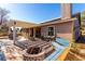 Home boasts covered patio, built-in seating, and decorative landscaping at 5552 Singing Hills Dr, Las Vegas, NV 89130