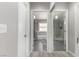 Bright bathroom featuring a tub, shower, and modern fixtures, visible through an open doorway at 5552 Singing Hills Dr, Las Vegas, NV 89130