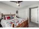 Bright bedroom featuring a full-sized bed, ceiling fan, and closet for ample storage at 5552 Singing Hills Dr, Las Vegas, NV 89130