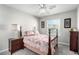 Cozy bedroom with a full-sized bed, ceiling fan, and bedside table, creating a relaxing atmosphere at 5552 Singing Hills Dr, Las Vegas, NV 89130