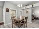 Cozy dining area featuring a round table with chairs, a chandelier, and natural light from windows at 5552 Singing Hills Dr, Las Vegas, NV 89130