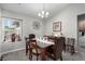 Well-lit dining area with seating for six, complemented by a decorative window and wall decor at 5552 Singing Hills Dr, Las Vegas, NV 89130
