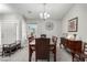 Formal dining room featuring a wooden table, chandelier, and decorative wall art at 5552 Singing Hills Dr, Las Vegas, NV 89130
