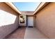 Entrance featuring light stucco walls, a white front door, and brick flooring at 5552 Singing Hills Dr, Las Vegas, NV 89130