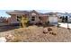 Charming single-story home featuring desert landscaping, tile roof, and a two-car garage at 5552 Singing Hills Dr, Las Vegas, NV 89130