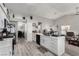 Bright kitchen featuring white cabinets, modern appliances, and seamless access to other living areas at 5552 Singing Hills Dr, Las Vegas, NV 89130
