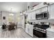 Open kitchen showcasing stainless steel appliances and an adjacent dining area with a window at 5552 Singing Hills Dr, Las Vegas, NV 89130