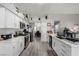 Bright kitchen features white cabinets, stainless steel appliances, and modern countertops with plank flooring at 5552 Singing Hills Dr, Las Vegas, NV 89130
