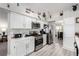 Bright kitchen features white cabinets, stainless steel appliances, and modern countertops at 5552 Singing Hills Dr, Las Vegas, NV 89130