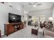 Inviting living room featuring a ceiling fan, high ceilings, a large TV, and cozy furnishings at 5552 Singing Hills Dr, Las Vegas, NV 89130