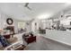 Spacious living area with a fireplace, kitchen access, and plenty of natural light at 5552 Singing Hills Dr, Las Vegas, NV 89130