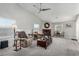 Bright living area with large windows, a cozy fireplace, and comfortable armchairs at 5552 Singing Hills Dr, Las Vegas, NV 89130