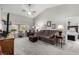 Comfortable living room with neutral color palette, ceiling fan, large TV, and ample seating at 5552 Singing Hills Dr, Las Vegas, NV 89130